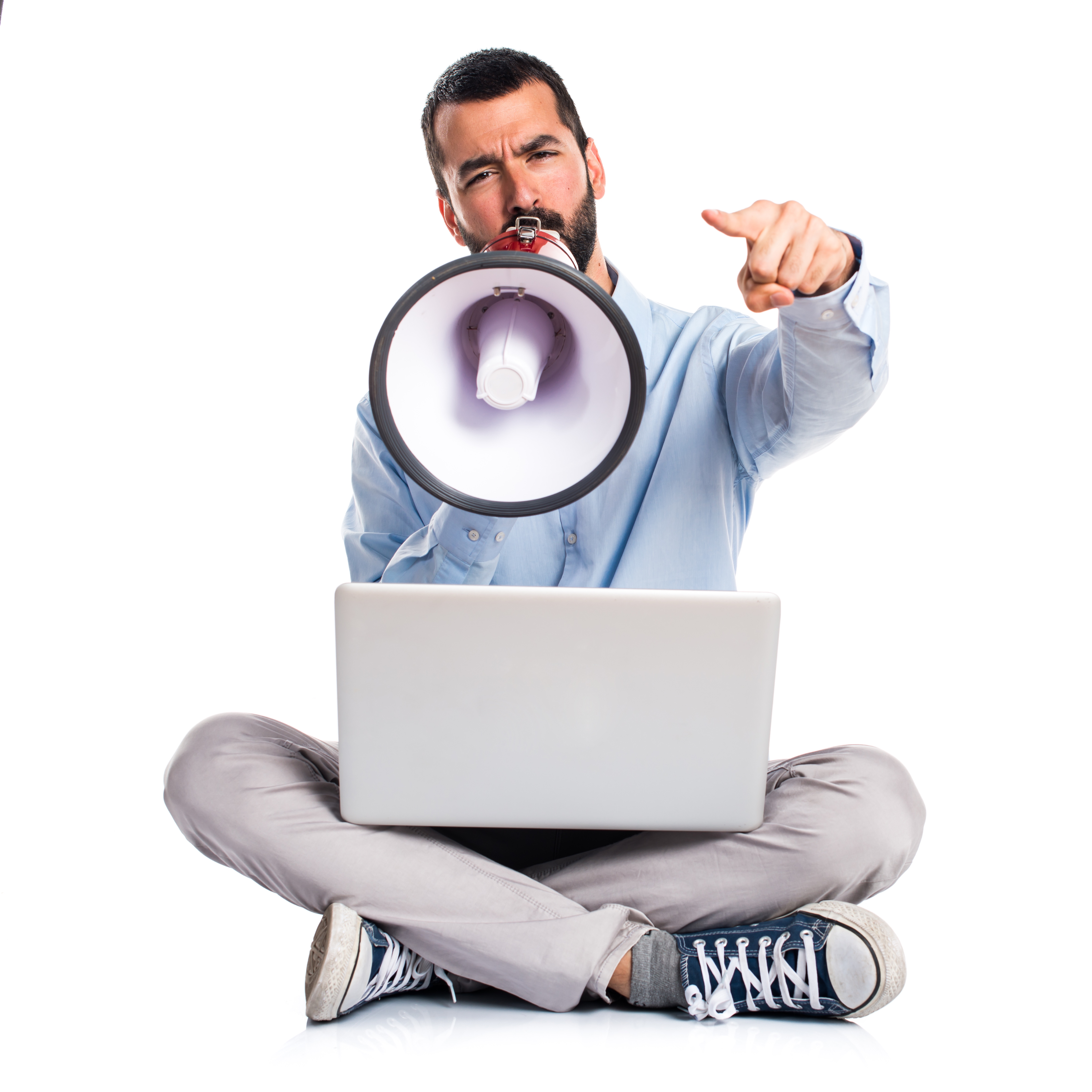 Man with laptop shouting by megaphone